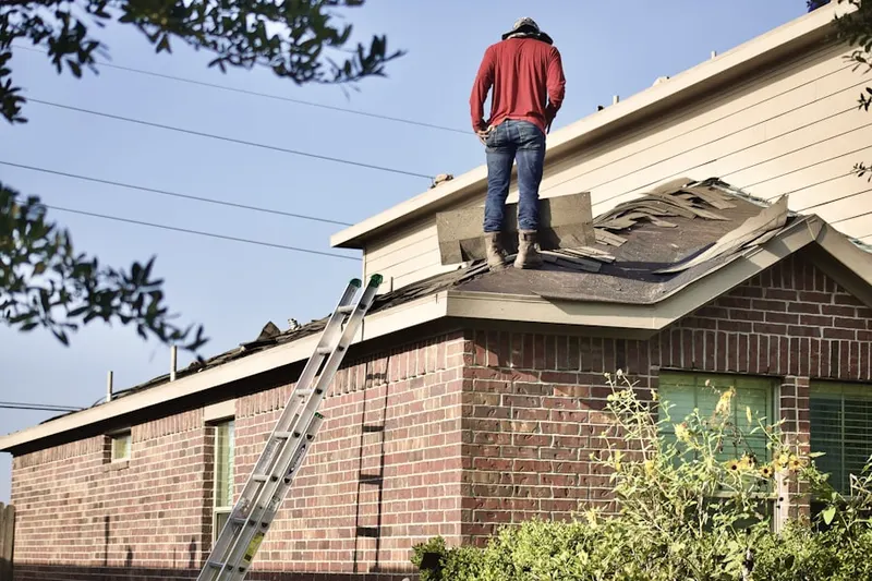 Professional roofer working on a residential roof in The Bluffs